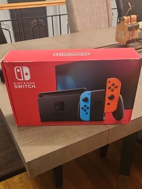 Nintendo Switch Console with Blue and Orange Joy-Con + Pokemon Sword Game